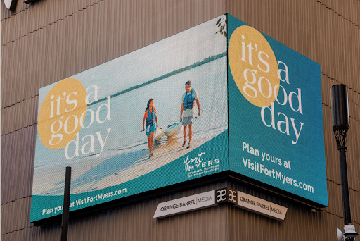 A picture of a digital billboard featuring the good day kayaking creative