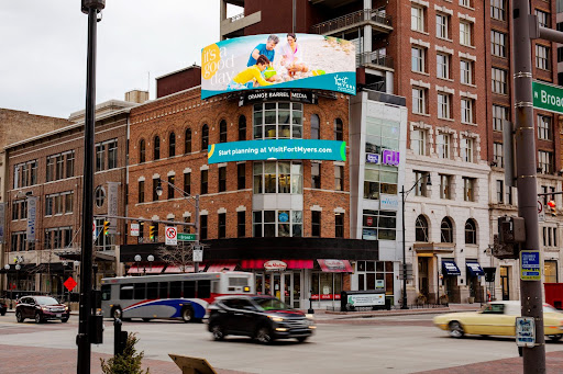 A picture of a digital billboard featuring the good day the beach creative