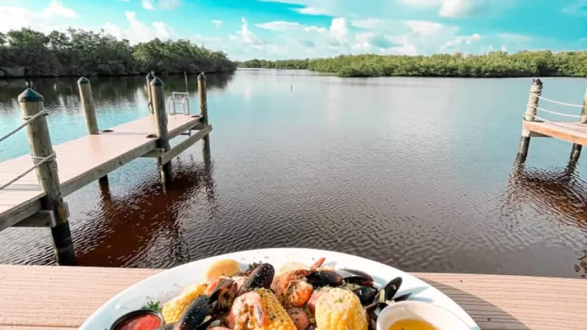 Waterfront dining scene with a plate of food on the dock