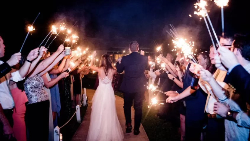 couple going between sparklers