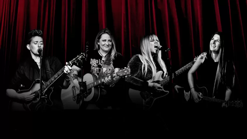 red curtains in background with four women in black and white shadows singing 