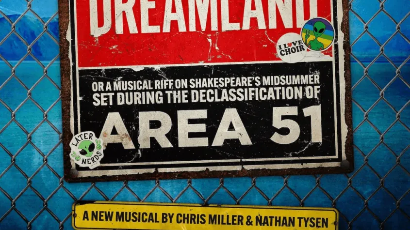 blue background with chainlink fence and singage saying dreamland and area 51