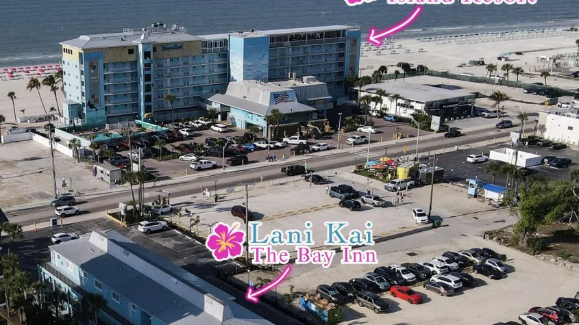 two blue hotels, one beachfront and one bayfront with the road separating the two, arrows pointing to each of the names