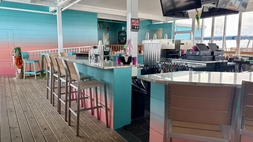 colorful bar area and wall, bar stools, tv 