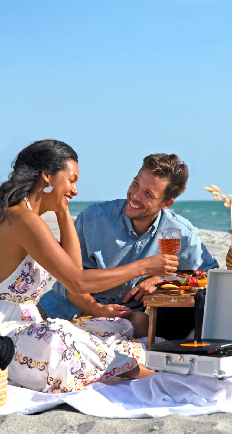 couple enjoying picnic on beach