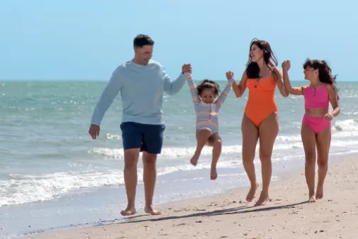 A family walks on the beach