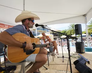 man playing guitar at island hopper fest