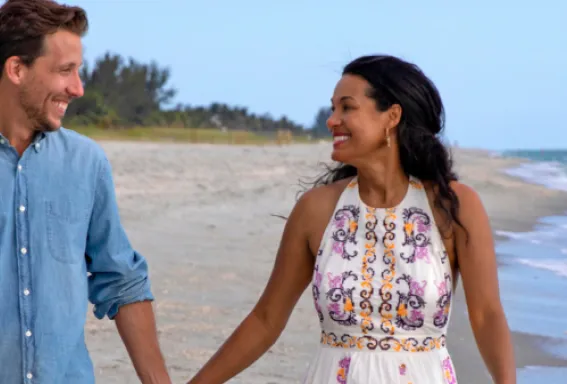 A couple walks along the beach on Sanibel Island