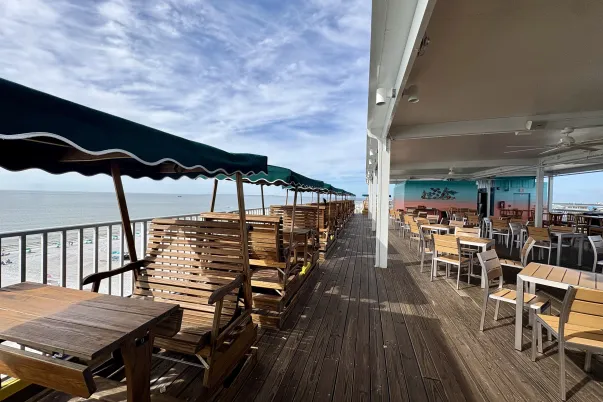 glider chairs with restaurant table and chairs, bright colors, blue skies, white clouds