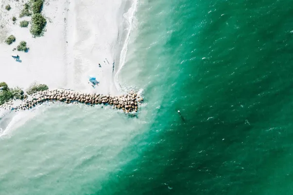 Aerial view of Blind Pass with white sand and turquoise water.