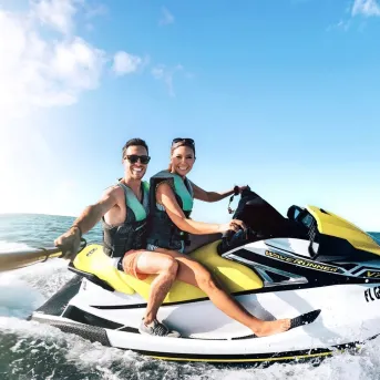 A couple enjoys a ride on a wave runner